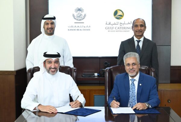 Kanoo Real Estate and Gulf Catering representatives signing a strategic partnership agreement.