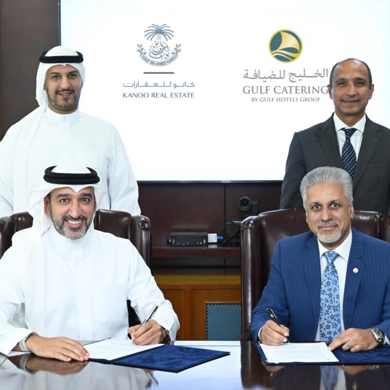 Kanoo Real Estate and Gulf Catering representatives signing a strategic partnership agreement.